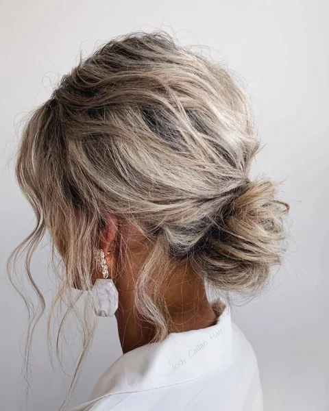 Messy Blonde Low Bun with Soft Dimensional Highlights