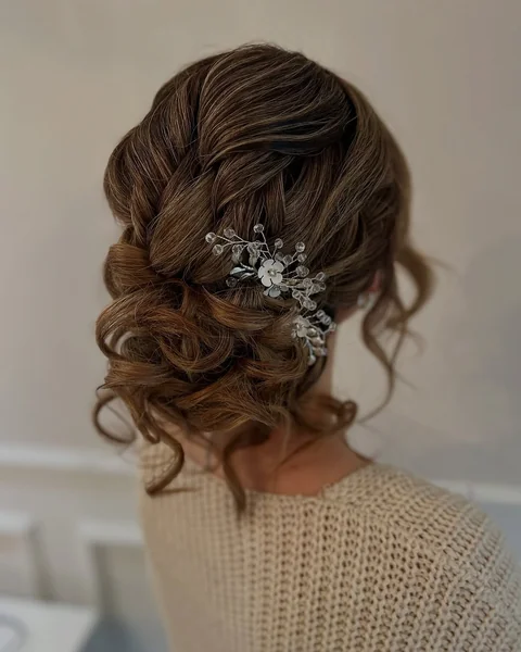 Messy Espresso Bun with Dramatic Face-Framing Spirals