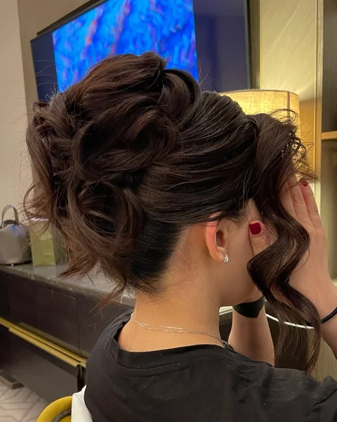 Romantic Deep Cocoa Messy Bun with Cascading Waves