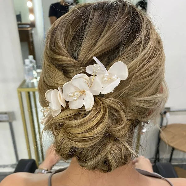 Romantic Messy Low Bun with Face-Framing Tendrils