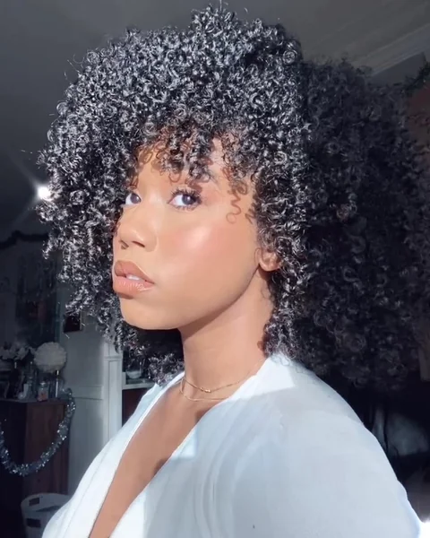 Side-Swept Raven Curls with Cascading Volume