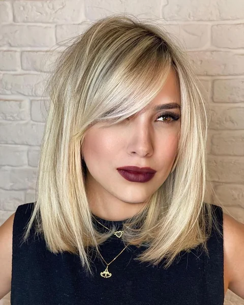 Sleek Blonde Lob with Deep Side-Swept Bangs