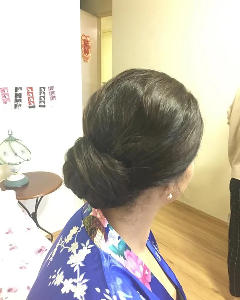Sophisticated Low Chignon with Polished Side-Swept Volume