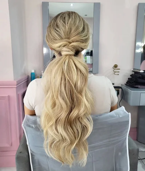 Twisted Blonde Low Ponytail with Textured Crown