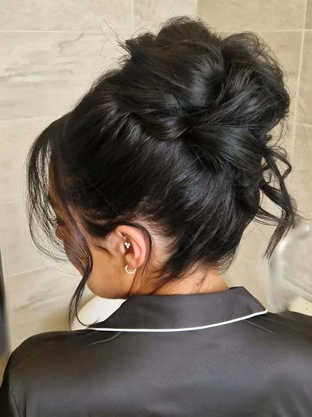 Voluminous Dark Textured High Bun with Side Swept Bangs