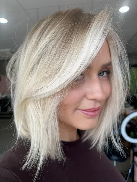 Voluminous Platinum Bob with Deep Side-Swept Bangs