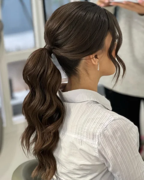 Polished Low Ponytail with Soft Barrel Waves