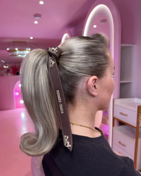 Retro-Flipped Dark Ponytail with Sculpted Edges