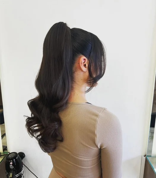Super-Sleek High Ponytail with Barrel-Curled Ends