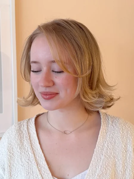 Romantic Boho Low Bun with Airy Face-Framing Bangs