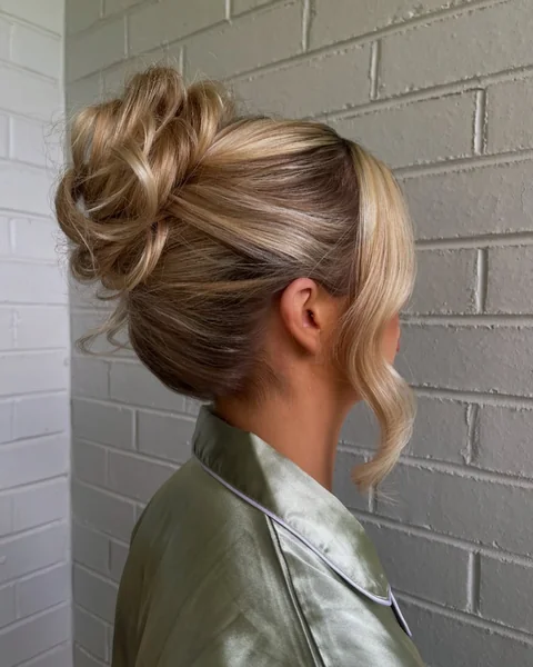 Sleek Midnight Top Knot with Glamorous Face-Framing Waves