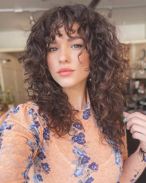 Voluminous Dark Shag with Curly Curtain Bangs