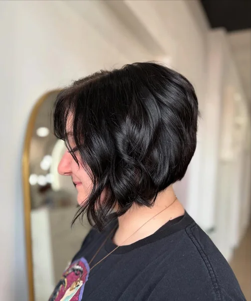 Wavy Midnight Black Stacked Bob with Face-Framing Tendrils